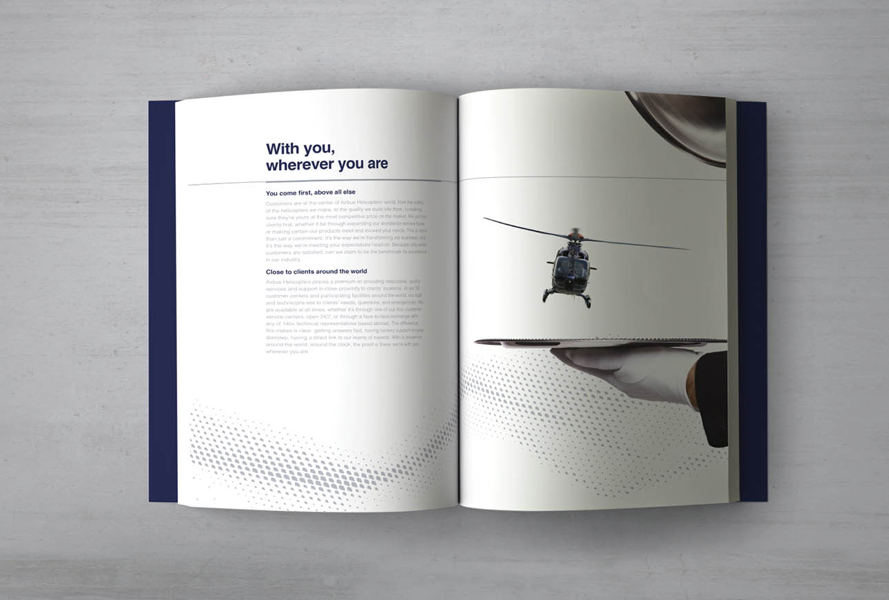 Open Airbus Helicopters brochure showing helicopter landing on serving tray concept, global service messaging layout