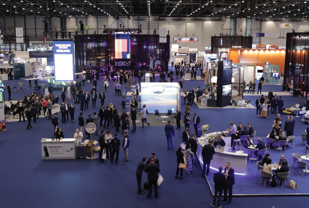Attendees networking at EBACE 2025 exhibition floor in Geneva aviation expo