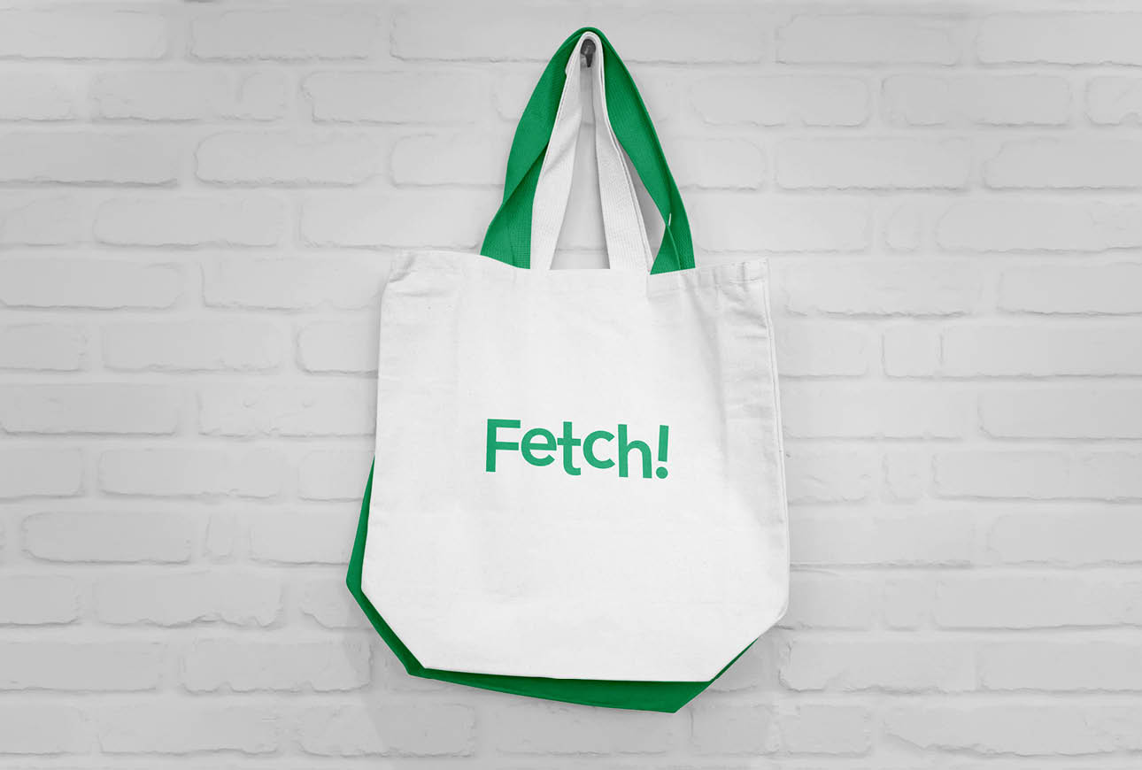 White tote bag with green handles featuring the Fetch logo