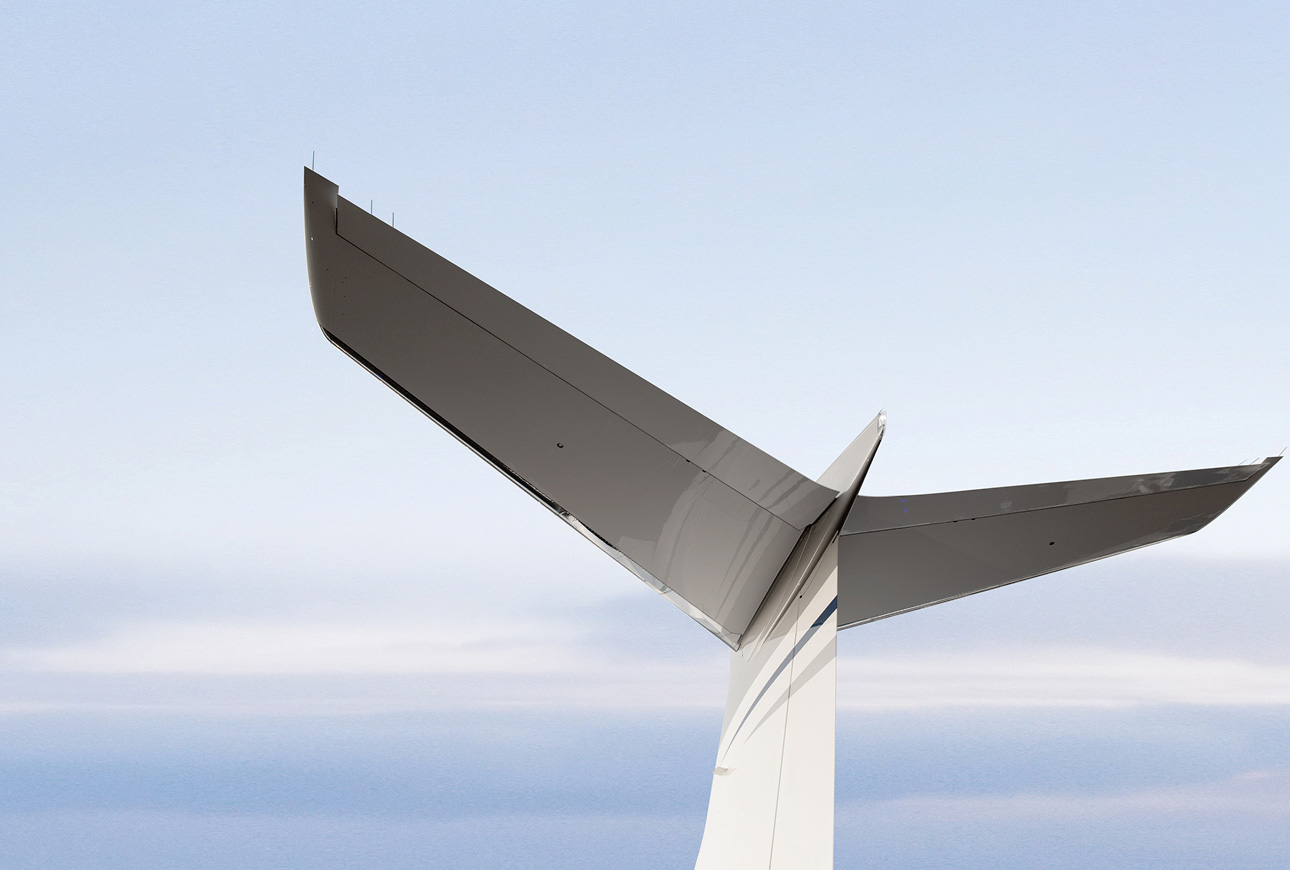 Private jet tail fin against clear sky, symbolizing global aviation and premium air travel