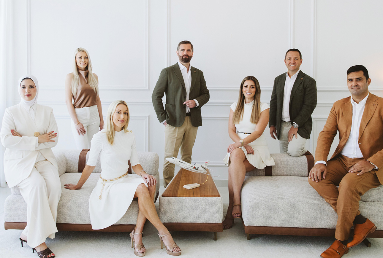 Diverse executive team seated in modern office representing private aviation company