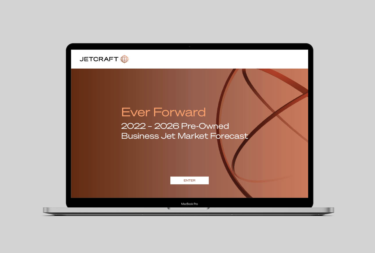 Laptop displaying Jetcraft Ever Forward 2022–2026 business jet market forecast landing page