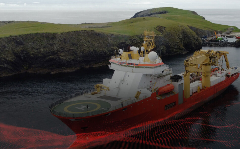 Offshore survey vessel operating near a rocky coastline during marine industrial operations